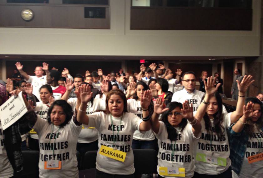 Immigrant rights activists pray during the hearing