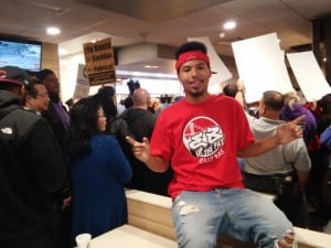 Isaiah Mitchelle, 19, poses for a photo amid early morning protests at a McDonalds in San Francisco. Isaiah works at Jack-In-the-Box for $9 an hour. Photo Credit: Mark Ortiz